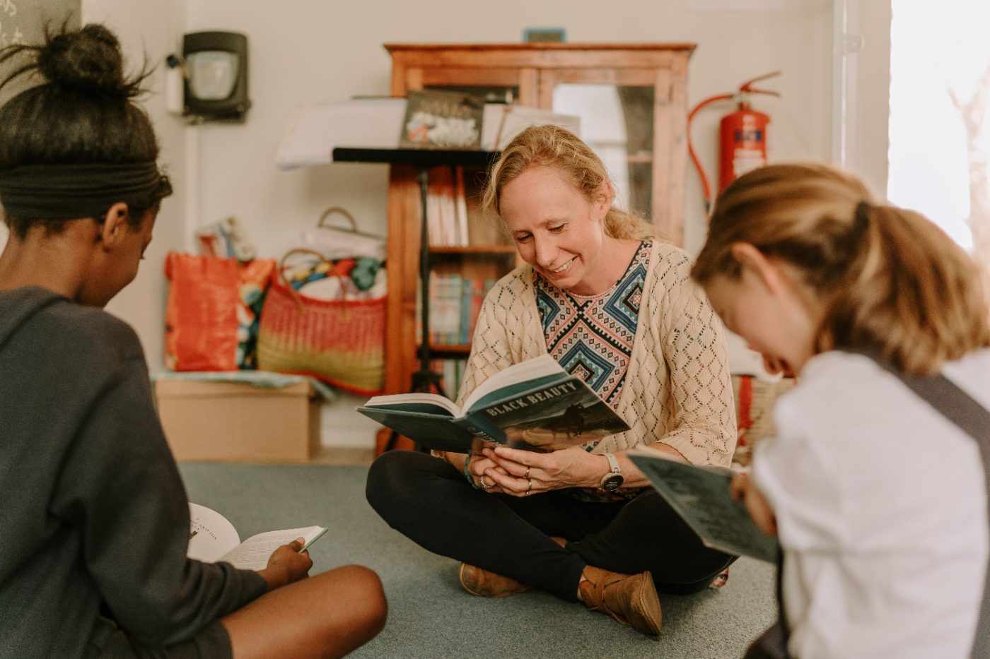 A teacher reading aloud with children