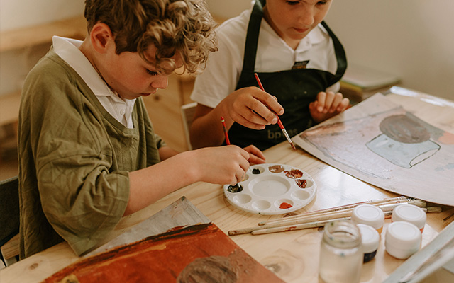 Children painting at Three Peaks School